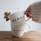 Handmade ceramic holiday mug lettered Merry and Bright in a neutral glaze