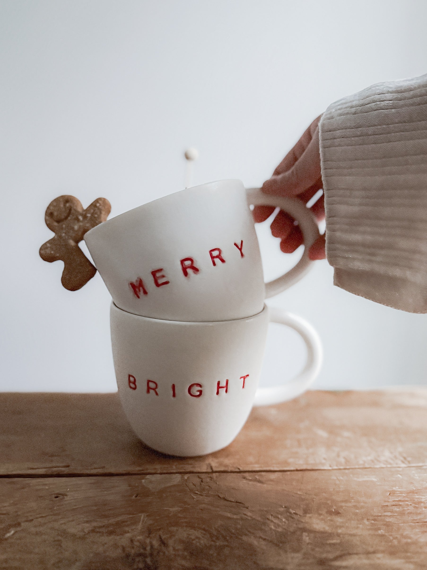 Handmade ceramic holiday mug lettered Merry and Bright in a neutral glaze