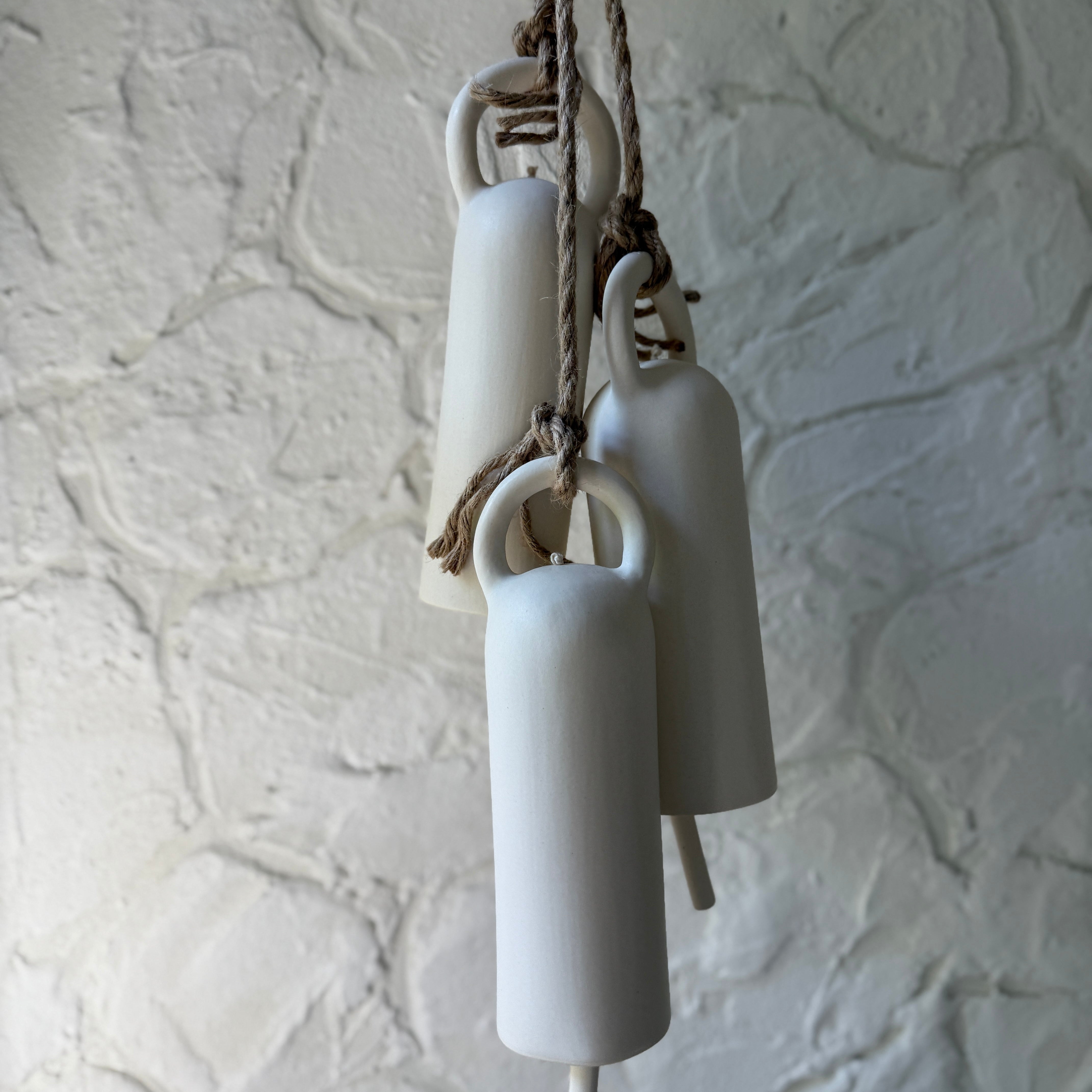 Handmade long ceramic bell with an elongated silhouette in a neutral finish