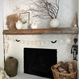 Handmade stoneware Halloween garland spelling SPOOKY on natural cotton rope in neutral tones.