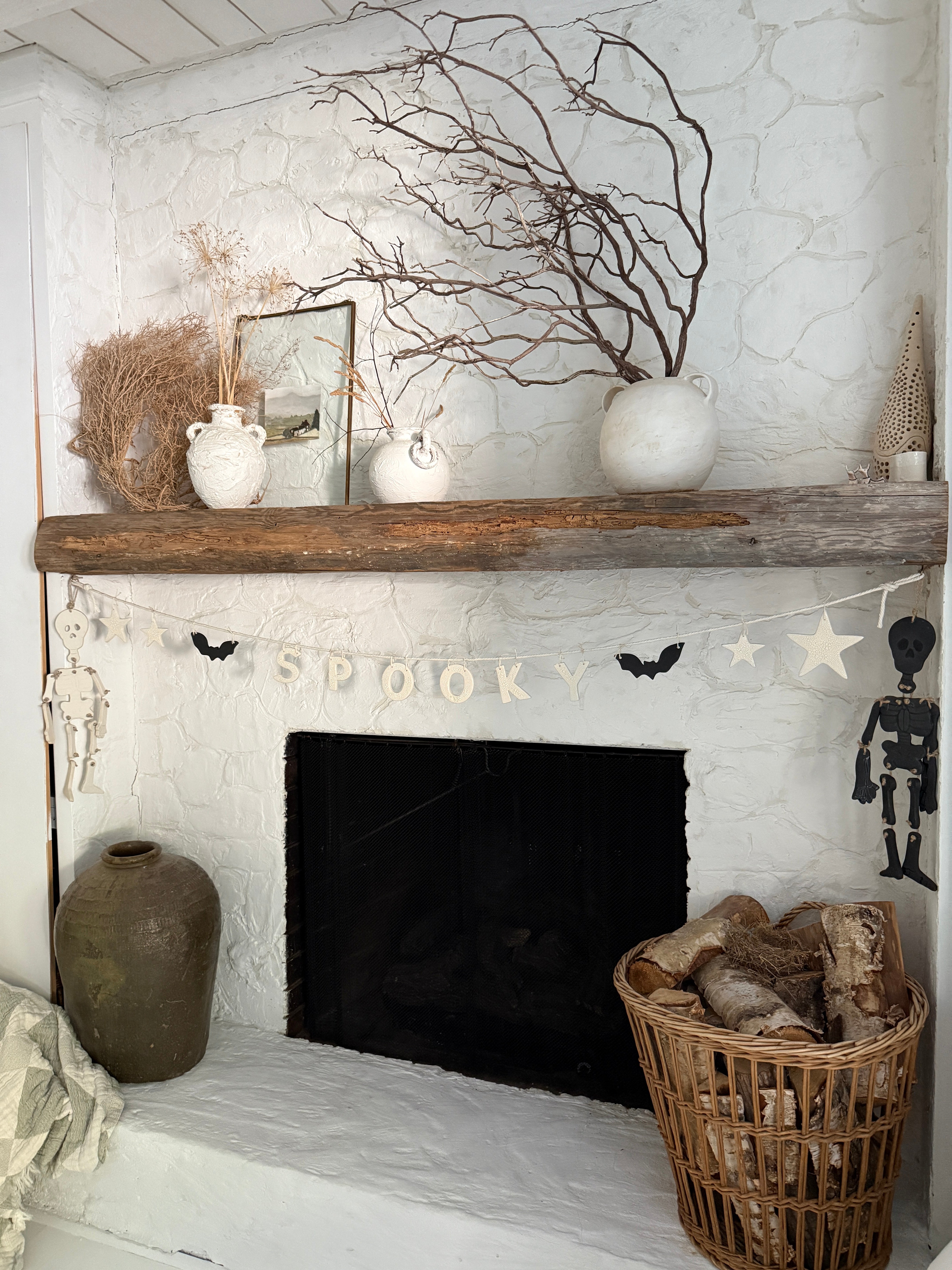 Handmade stoneware Halloween garland spelling SPOOKY on natural cotton rope in neutral tones.