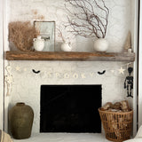 Handmade stoneware Halloween garland spelling SPOOKY on natural cotton rope in neutral tones.