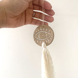 Handcrafted ceramic evil eye ornament with tassel, boho wall decor