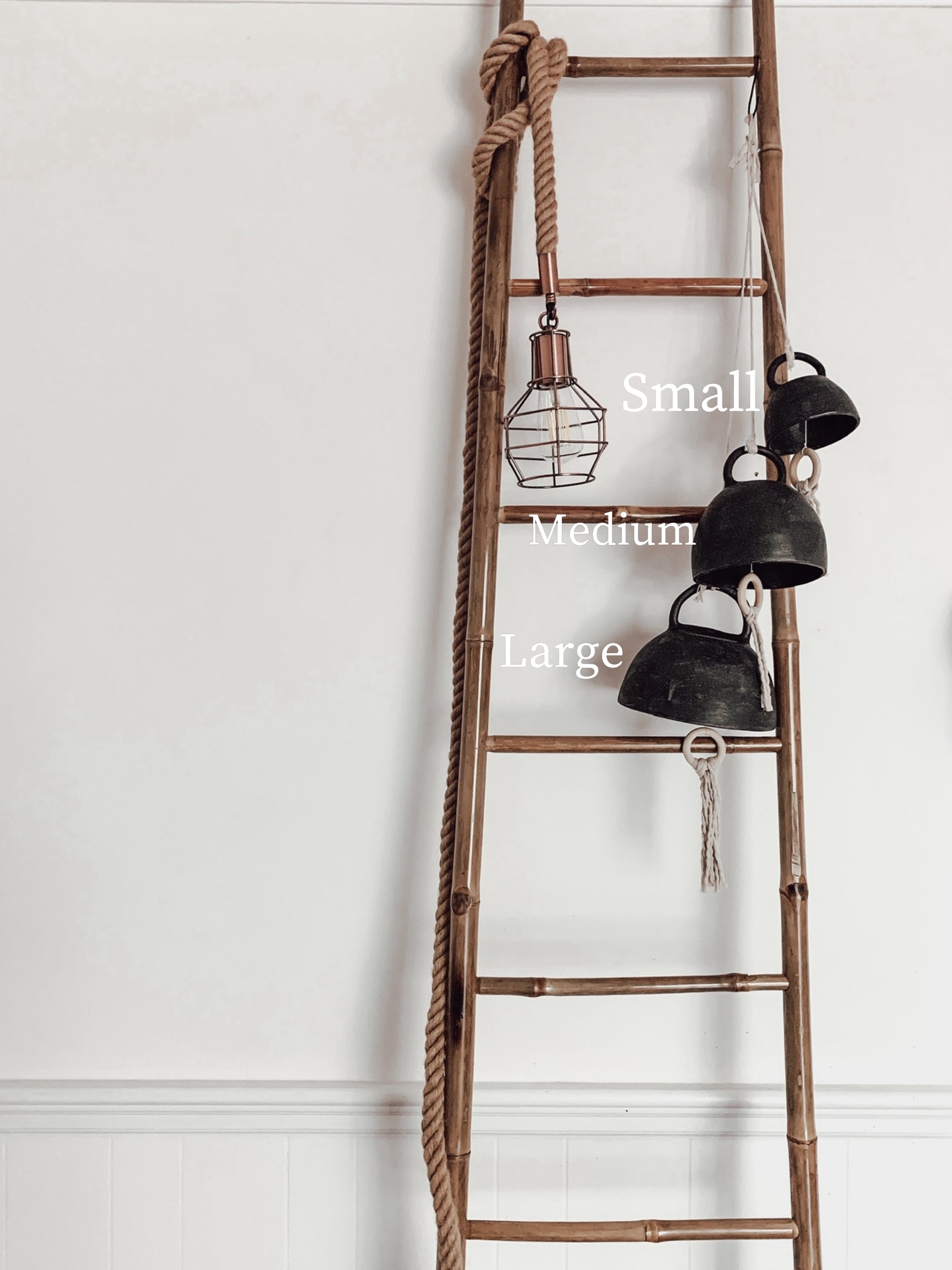 Handmade ceramic bell chime with wooden clapper in a neutral finish