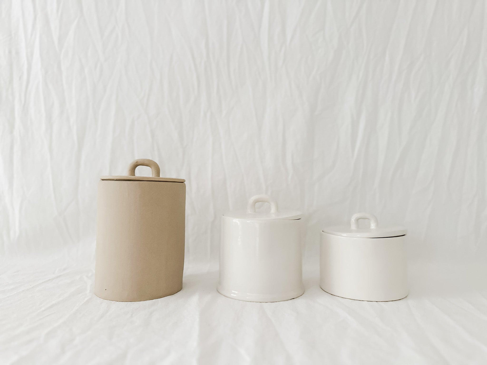 Handmade lidded ceramic storage canister with a loop handle