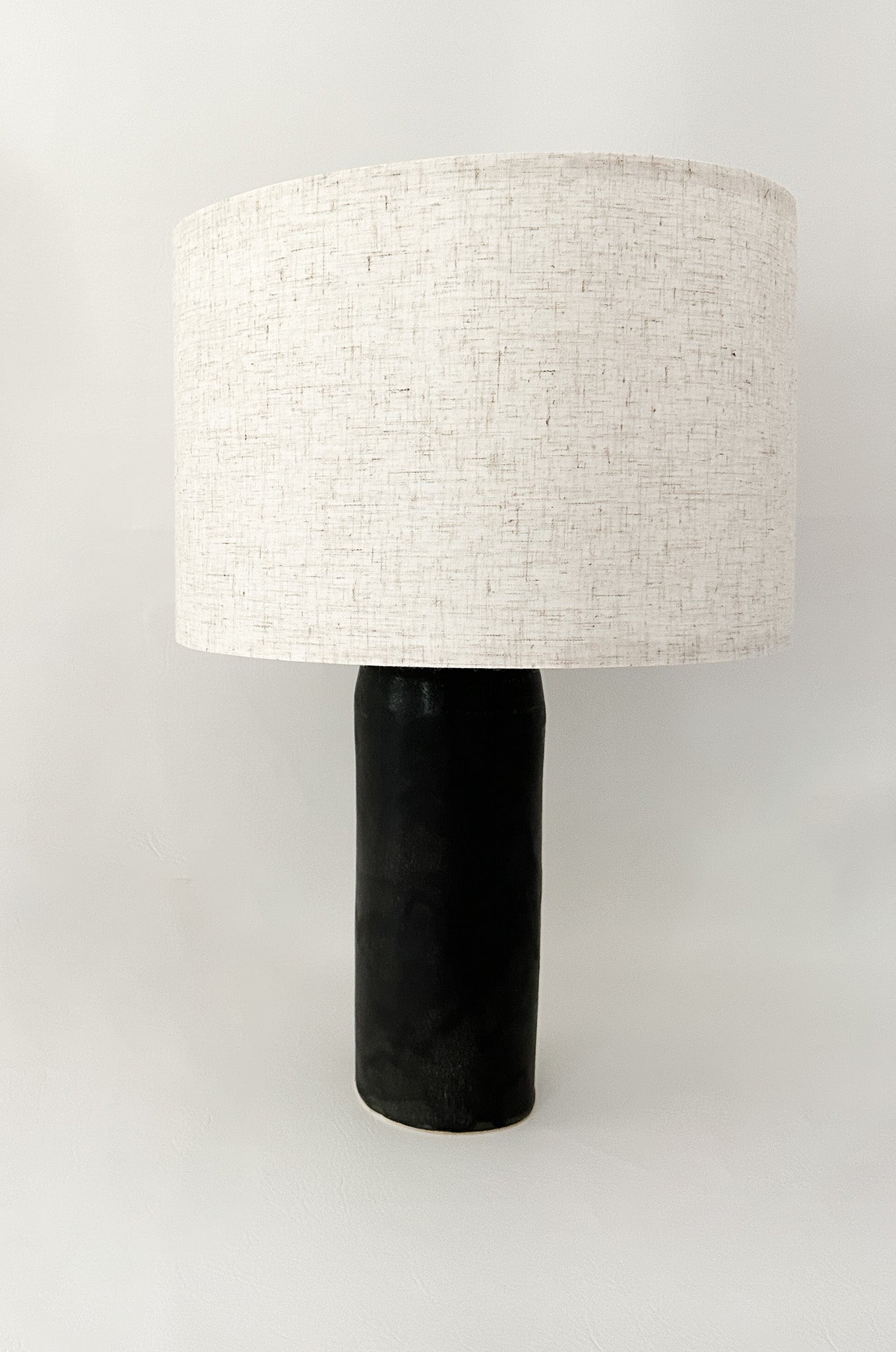 Handmade ceramic bedside lamp with linen shade and silver hardware