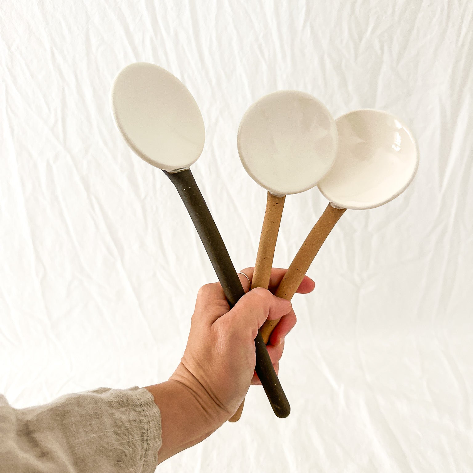 Handmade ceramic coffee and spice spoons in buff and espresso glazes, seconds-sale pieces from Muddy Heart