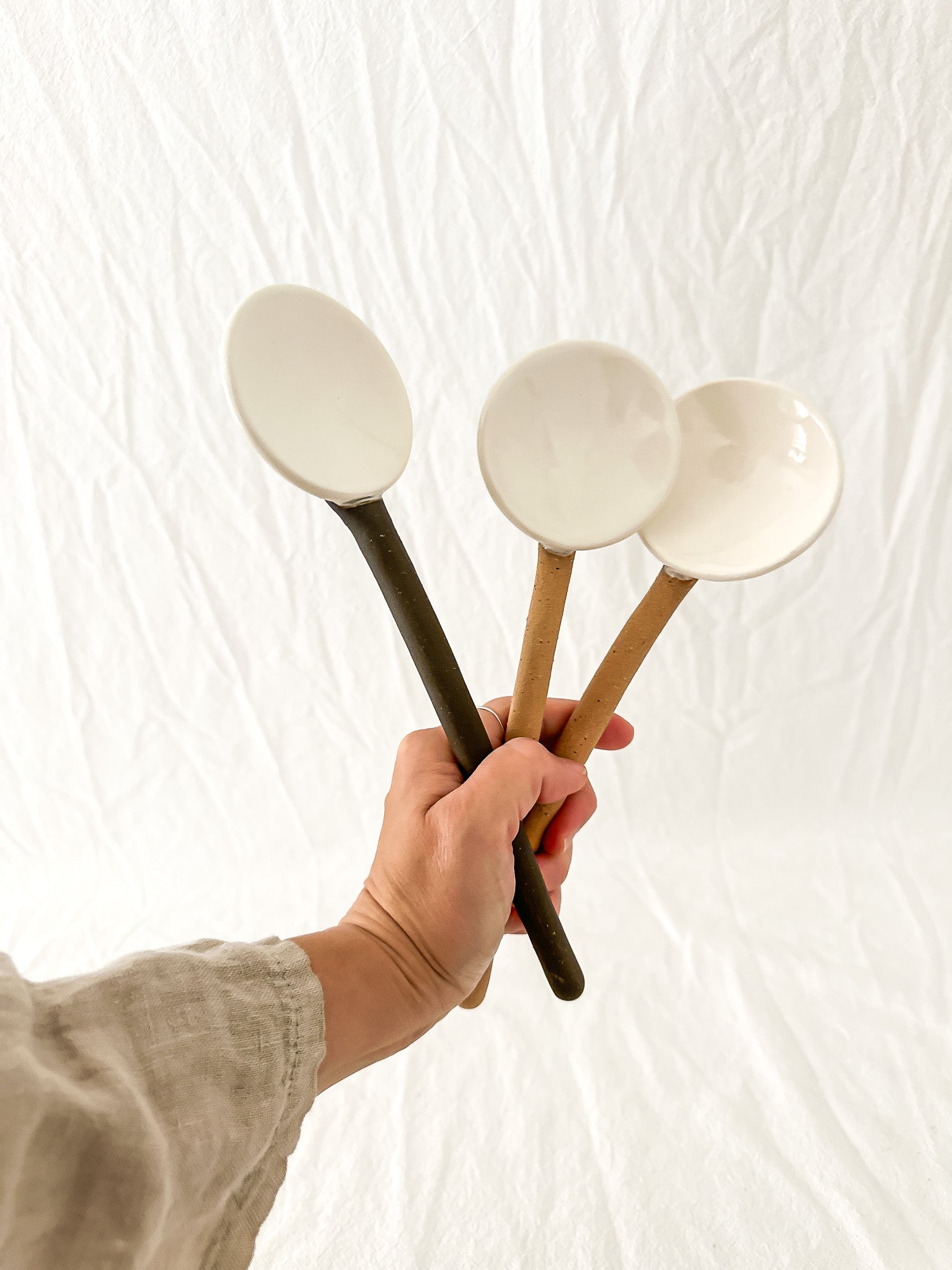 Handmade ceramic coffee and spice spoons in buff and espresso glazes, seconds-sale pieces from Muddy Heart