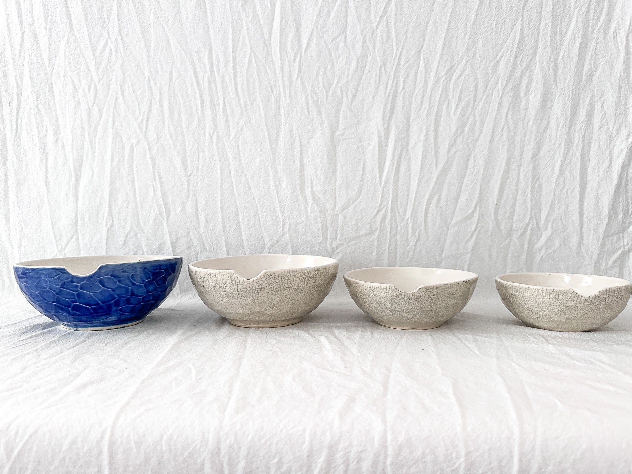 Handmade ceramic kitchen bowls in crackle white and cobalt blue glaze, dishwasher-safe seconds-sale pieces from Muddy Heart