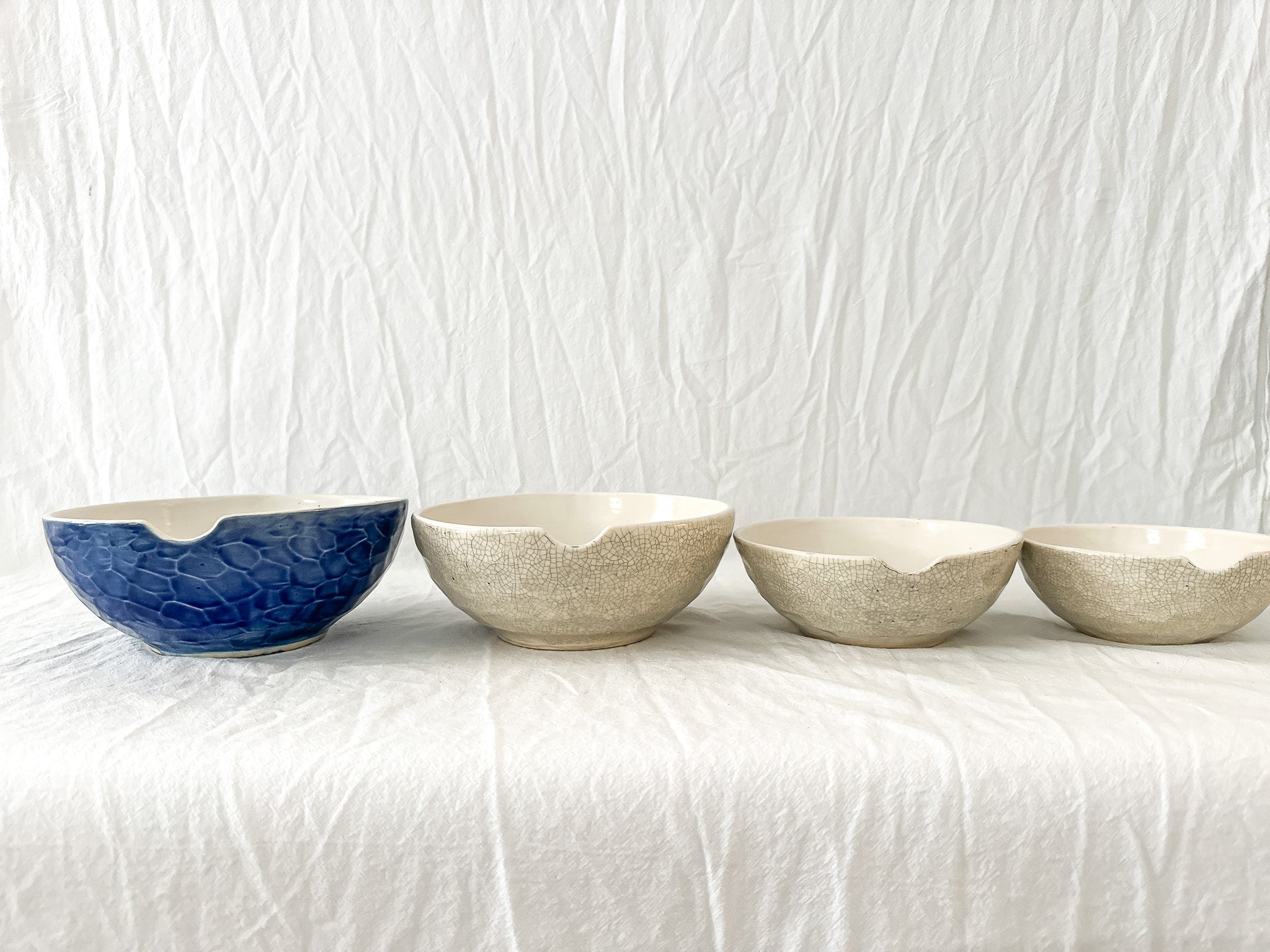 Handmade ceramic kitchen bowls in crackle white and cobalt blue glaze, dishwasher-safe seconds-sale pieces from Muddy Heart