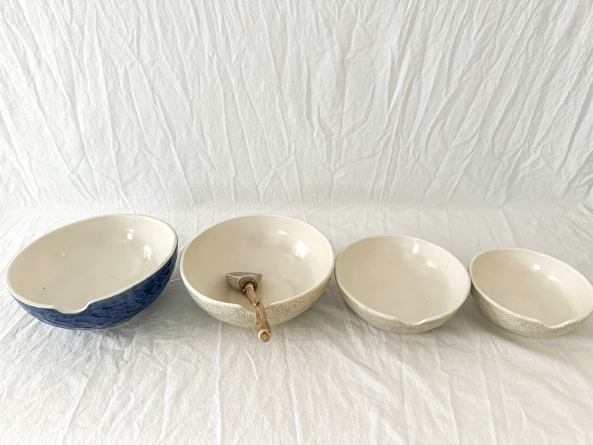 Handmade ceramic kitchen bowls in crackle white and cobalt blue glaze, dishwasher-safe seconds-sale pieces from Muddy Heart