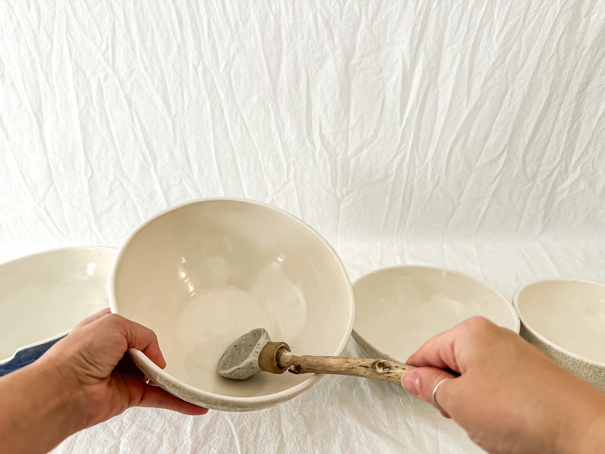 Handmade ceramic kitchen bowls in crackle white and cobalt blue glaze, dishwasher-safe seconds-sale pieces from Muddy Heart