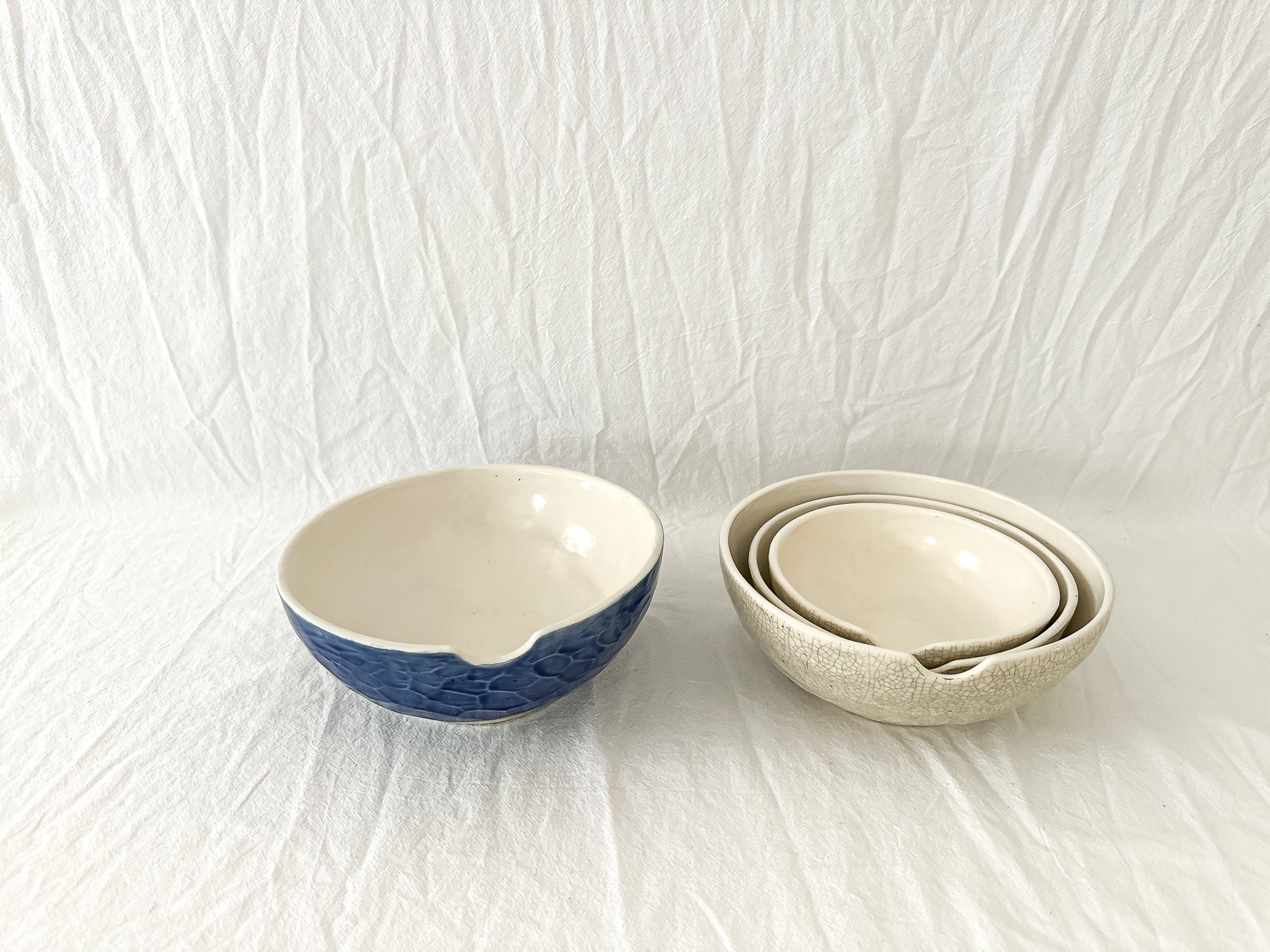 Handmade ceramic kitchen bowls in crackle white and cobalt blue glaze, dishwasher-safe seconds-sale pieces from Muddy Heart