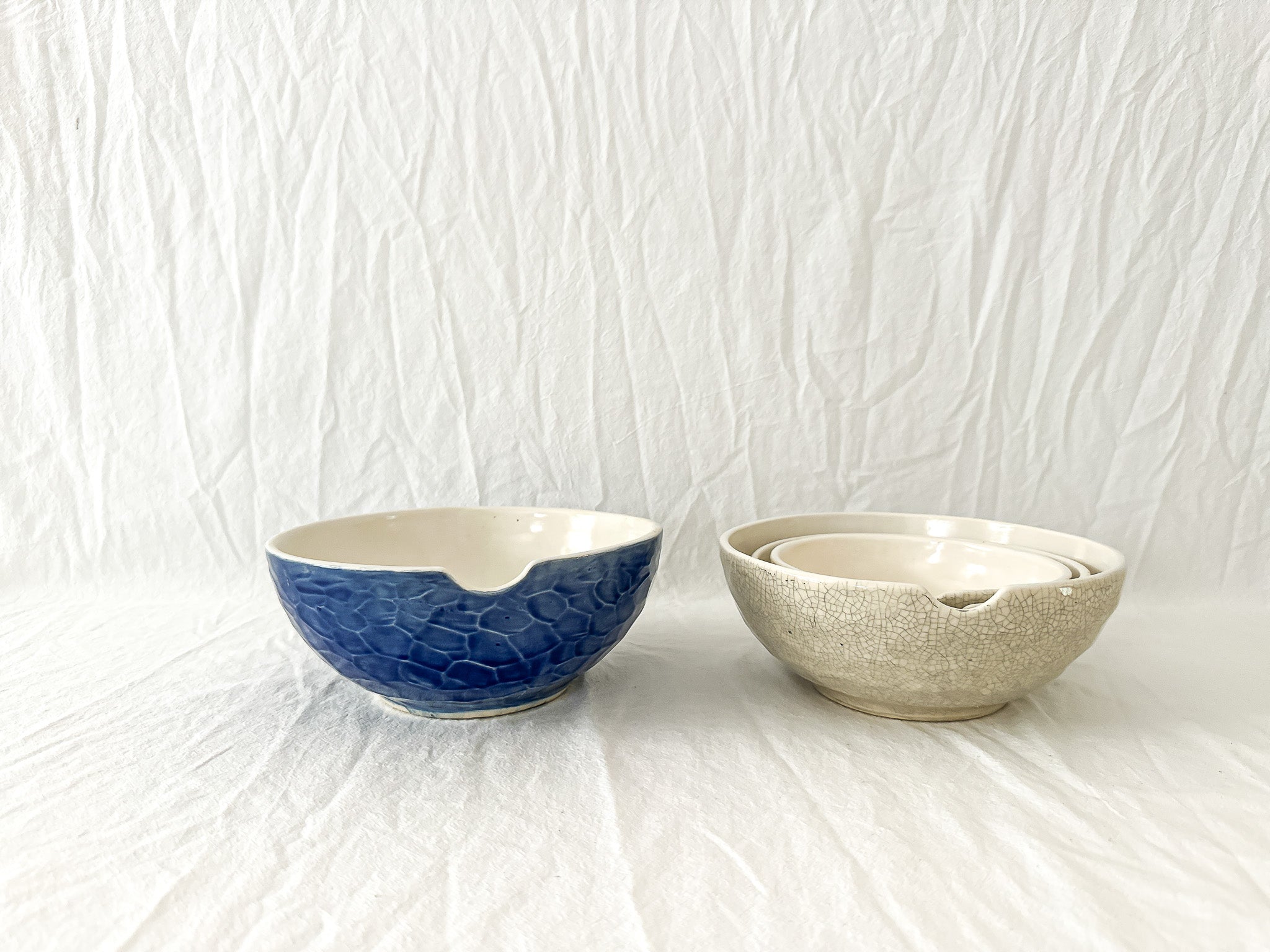 Handmade ceramic kitchen bowls in crackle white and cobalt blue glaze, dishwasher-safe seconds-sale pieces from Muddy Heart