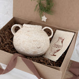 Handmade ceramic olive jar with a soft old-world texture in a neutral finish.