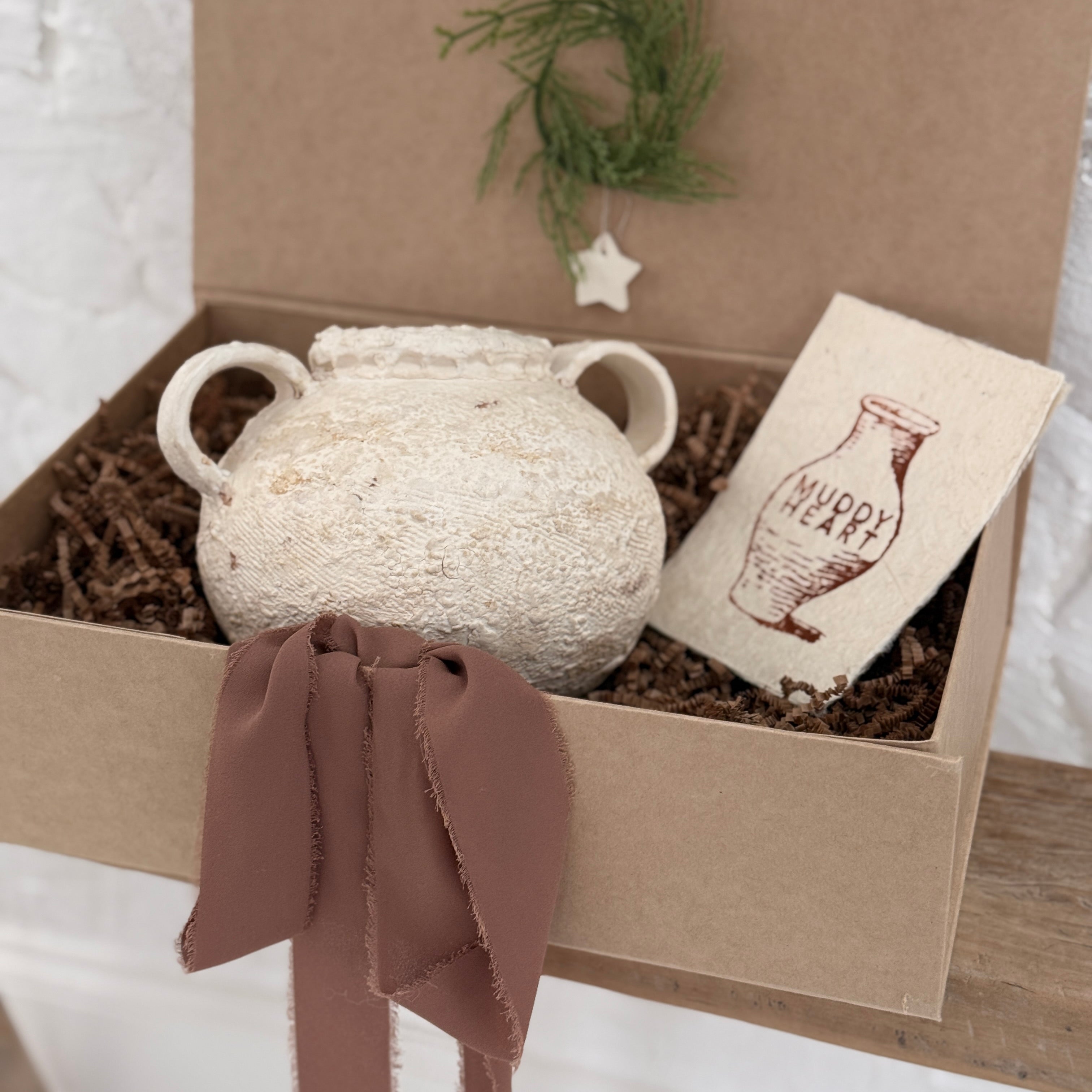 Handmade ceramic olive jar with a soft old-world texture in a neutral finish.