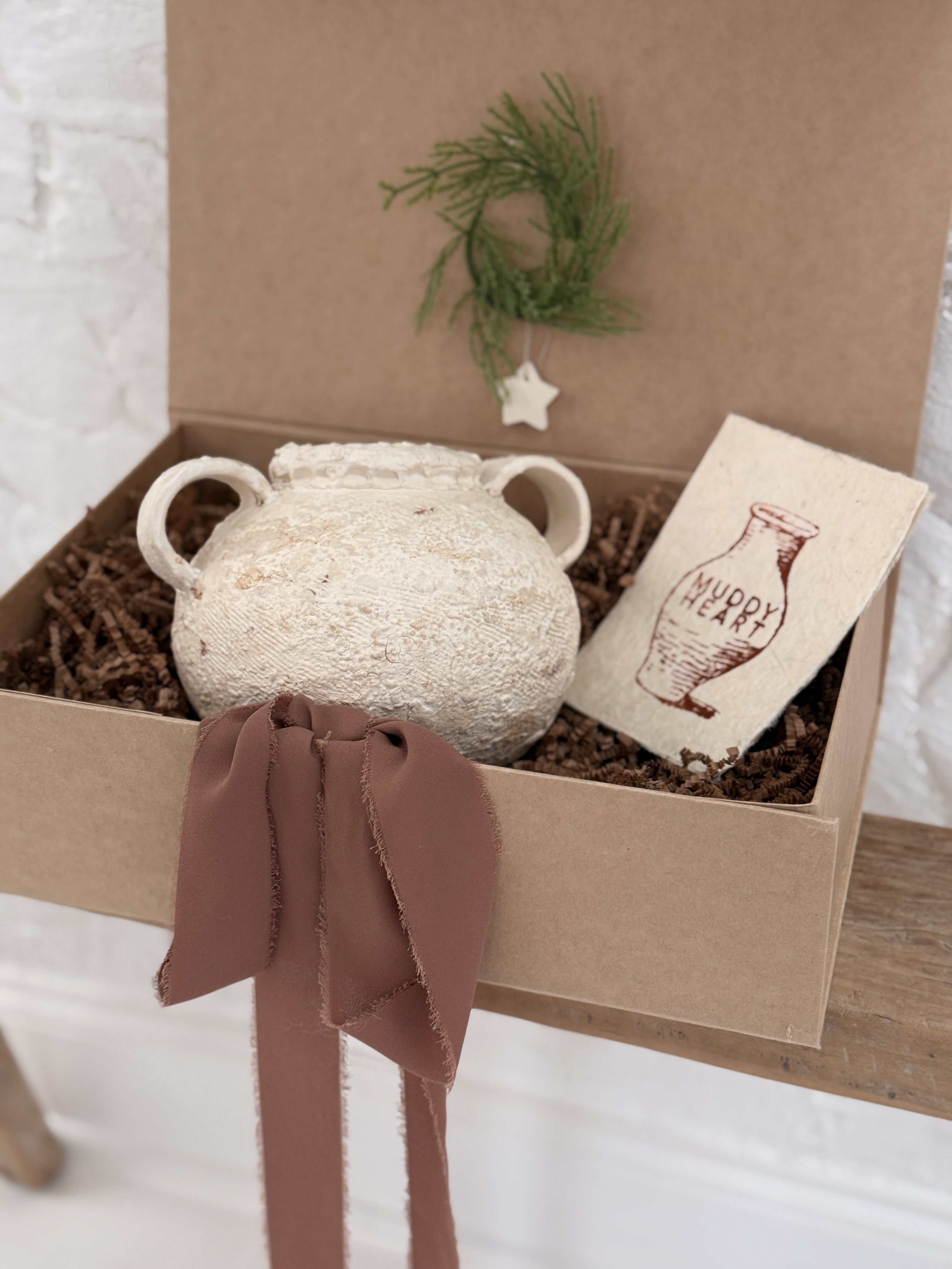 Handmade ceramic olive jar with a soft old-world texture in a neutral finish.