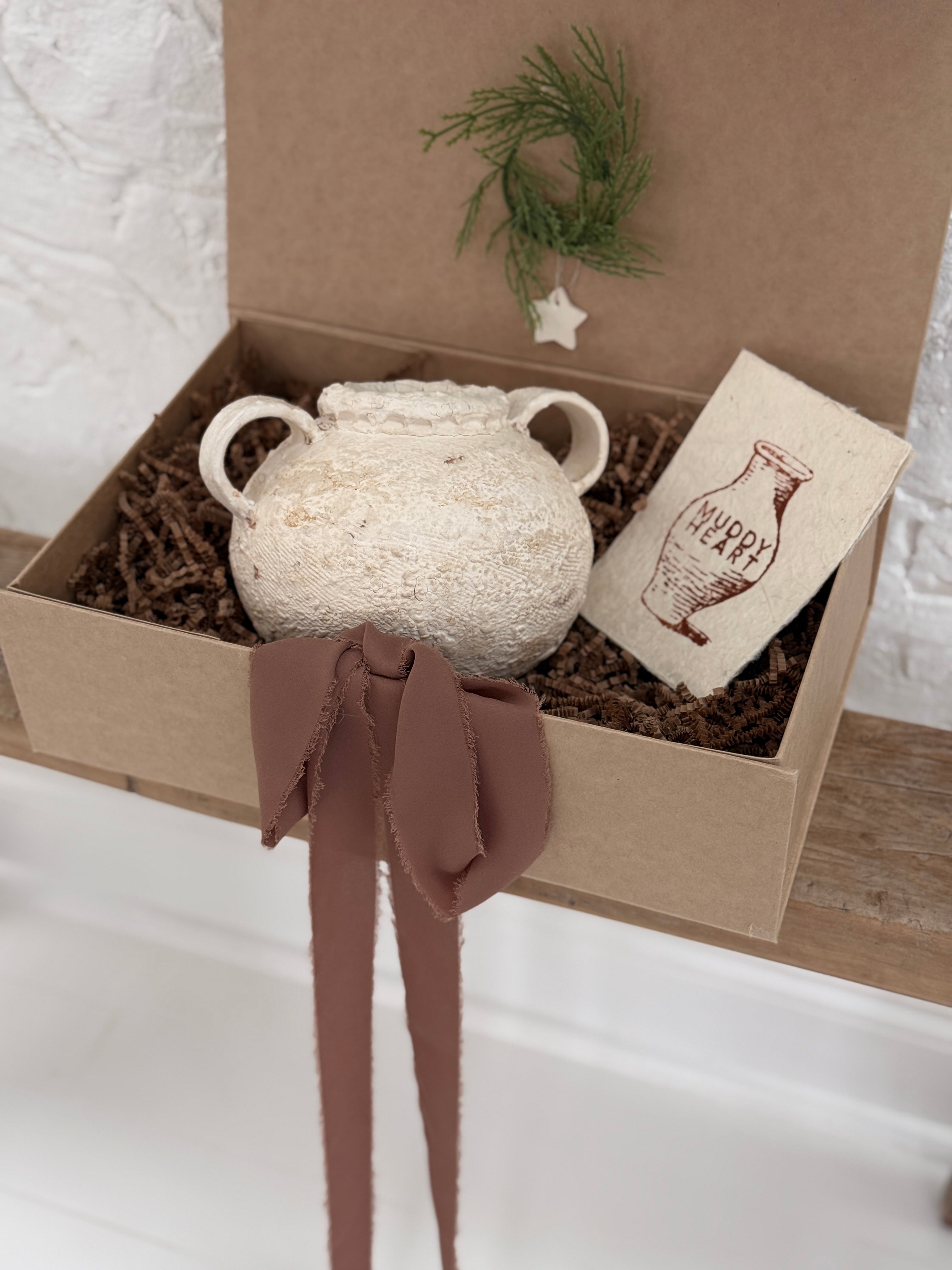 Handmade ceramic olive jar with a soft old-world texture in a neutral finish.