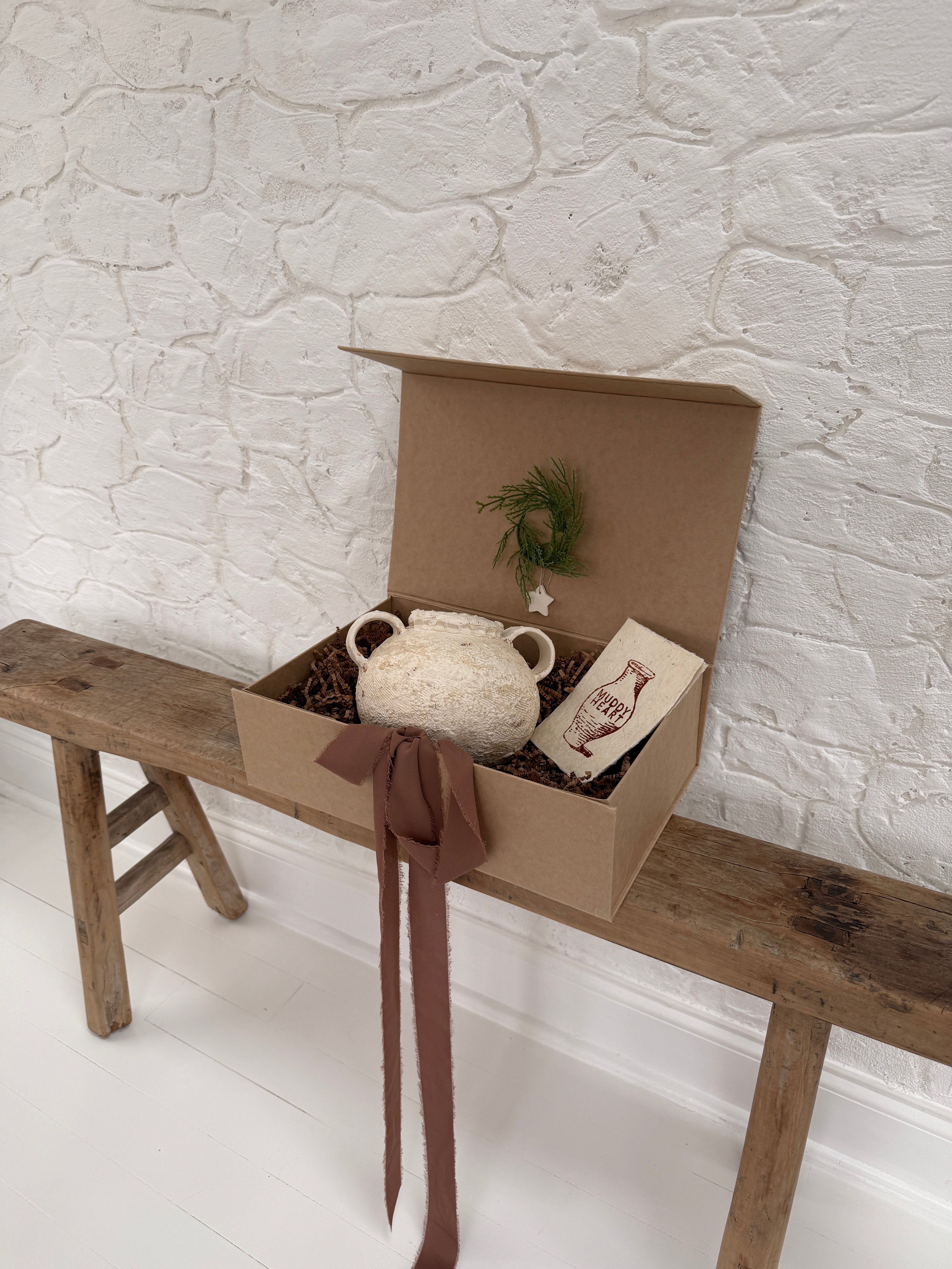 Handmade ceramic olive jar with a soft old-world texture in a neutral finish.