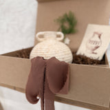 Small handmade ceramic vessel with a softly textured neutral finish, styled as a vase and shelf accent.