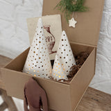Handmade ceramic luminary tree set glowing with LED tea lights in a ready-to-gift holiday box.