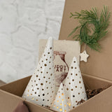 Handmade ceramic luminary tree set glowing with LED tea lights in a ready-to-gift holiday box.