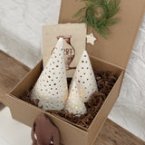 Handmade ceramic luminary tree set glowing with LED tea lights in a ready-to-gift holiday box.