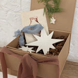 Pair of handmade glossy white ceramic North Star ornaments, one large and one small, tied with ribbon for hanging.