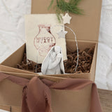 Handmade white ceramic nativity with a delicate star arch, softly sculpted in a minimal modern form.