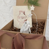 Handmade white ceramic nativity with a delicate star arch, softly sculpted in a minimal modern form.