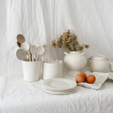 Frost-white footed ceramic vase with a full bellied body and pedestal foot, handmade