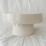 Handmade white ceramic cake stand with a delicate lace-textured plate in glossy white glaze, made to order by Muddy Heart