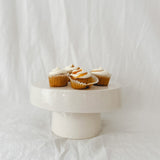 Handmade white ceramic cake stand with a delicate lace-textured plate in glossy white glaze, made to order by Muddy Heart