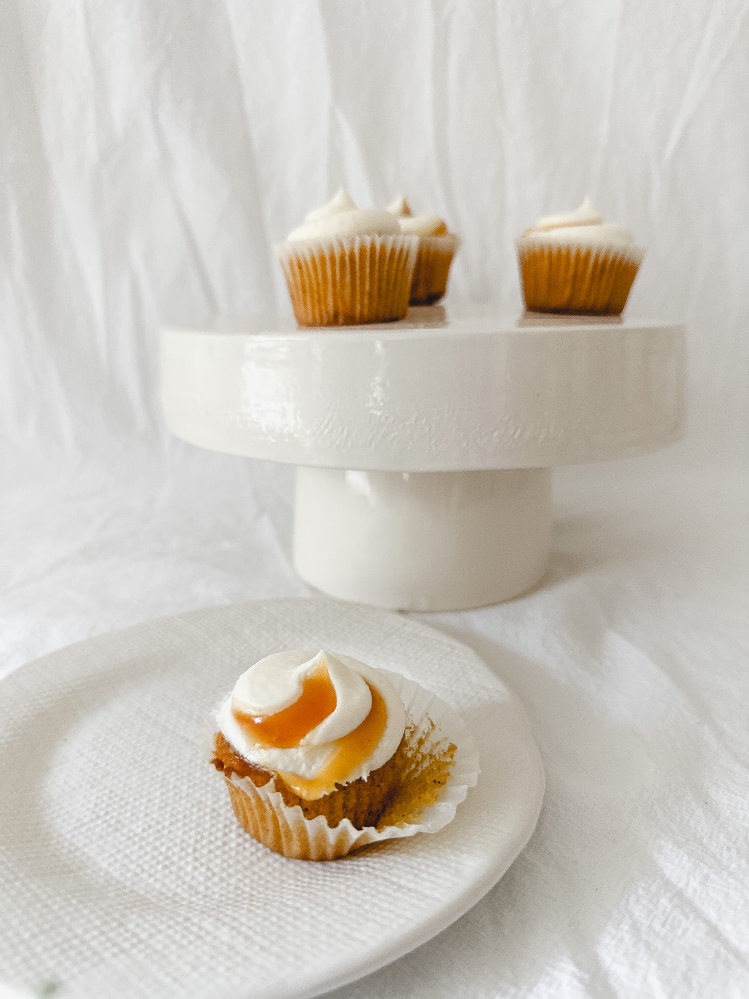 Handmade white ceramic cake stand with a delicate lace-textured plate in glossy white glaze, made to order by Muddy Heart