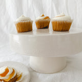 Handmade white ceramic cake stand with a delicate lace-textured plate in glossy white glaze, made to order by Muddy Heart