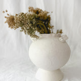 Handmade footed ceramic vase in frost-white glaze with a rounded bellied silhouette, 7 inches wide