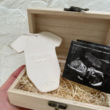 Personalized ceramic baby announcement ornament with an ultrasound photo, a keepsake for new grandparents