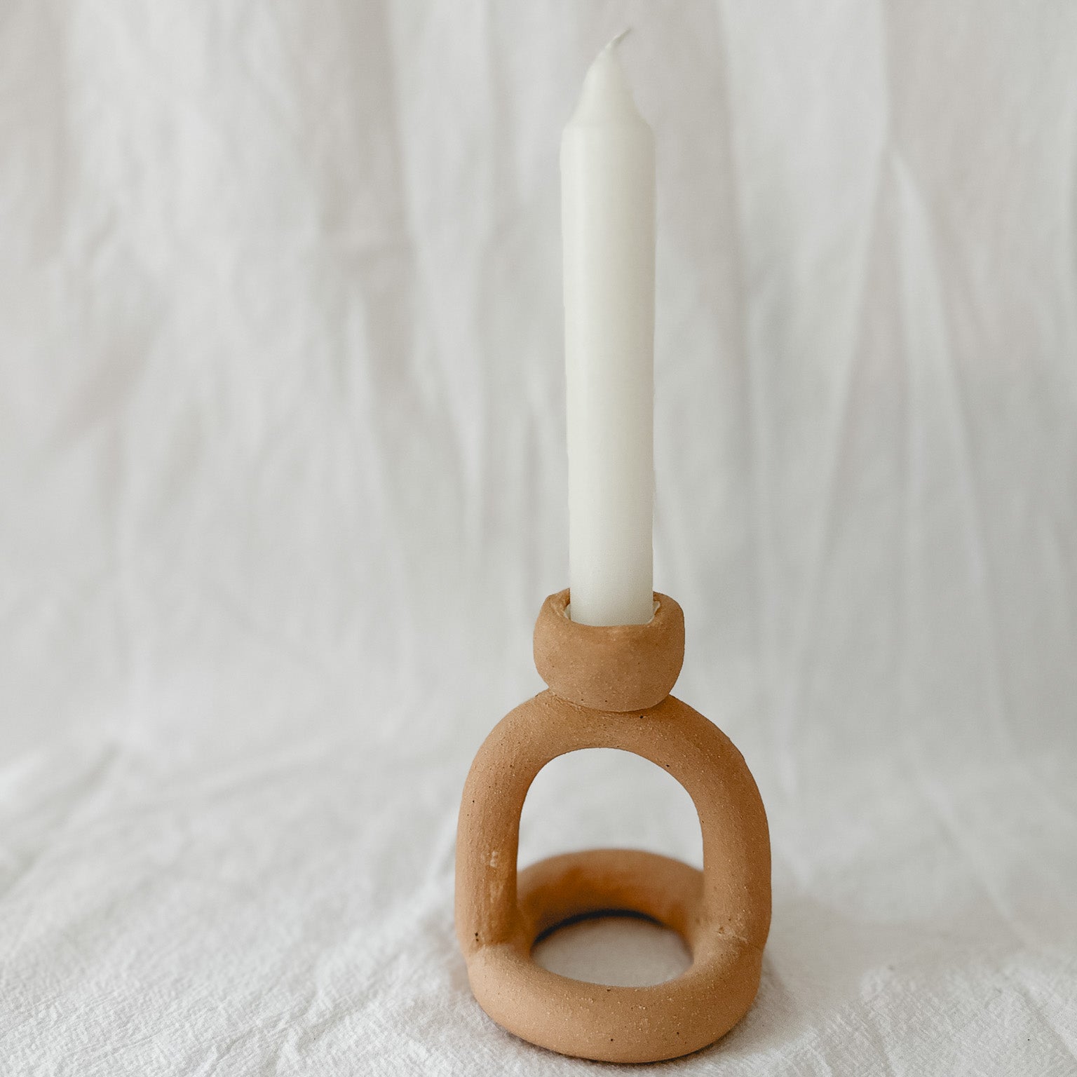Handmade ceramic arc-shaped taper candle holder, seconds-sale piece from Muddy Heart