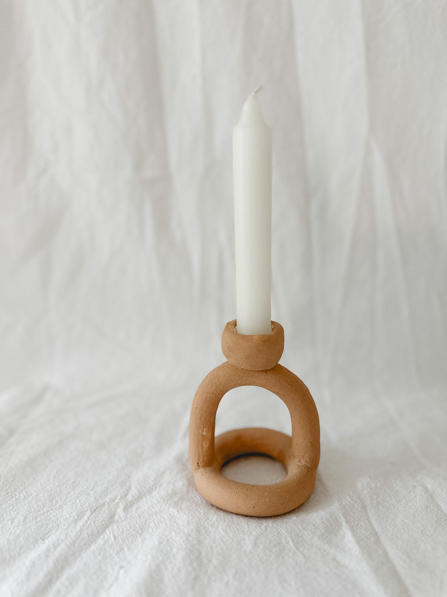 Handmade ceramic arc-shaped taper candle holder, seconds-sale piece from Muddy Heart