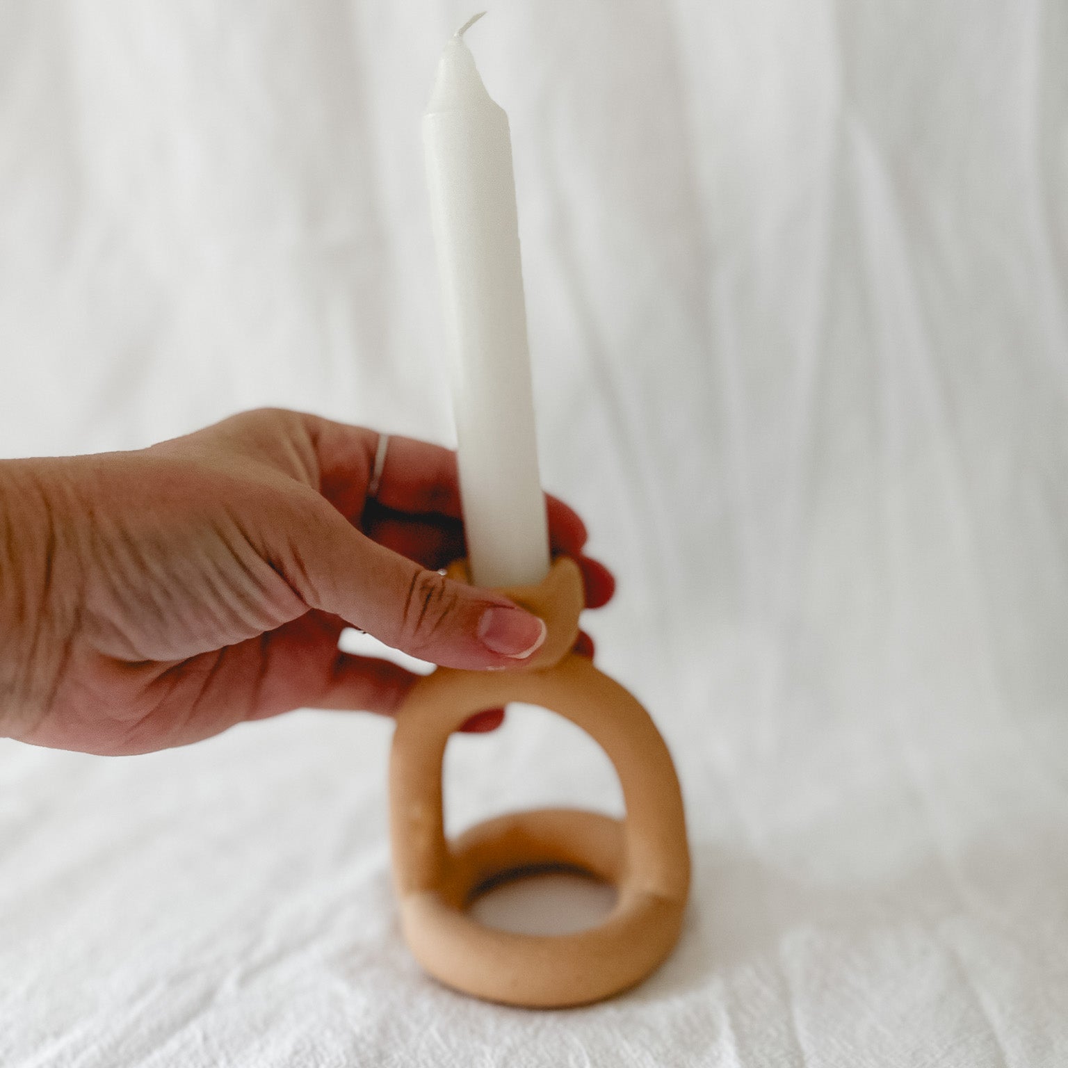 Handmade ceramic arc-shaped taper candle holder, seconds-sale piece from Muddy Heart