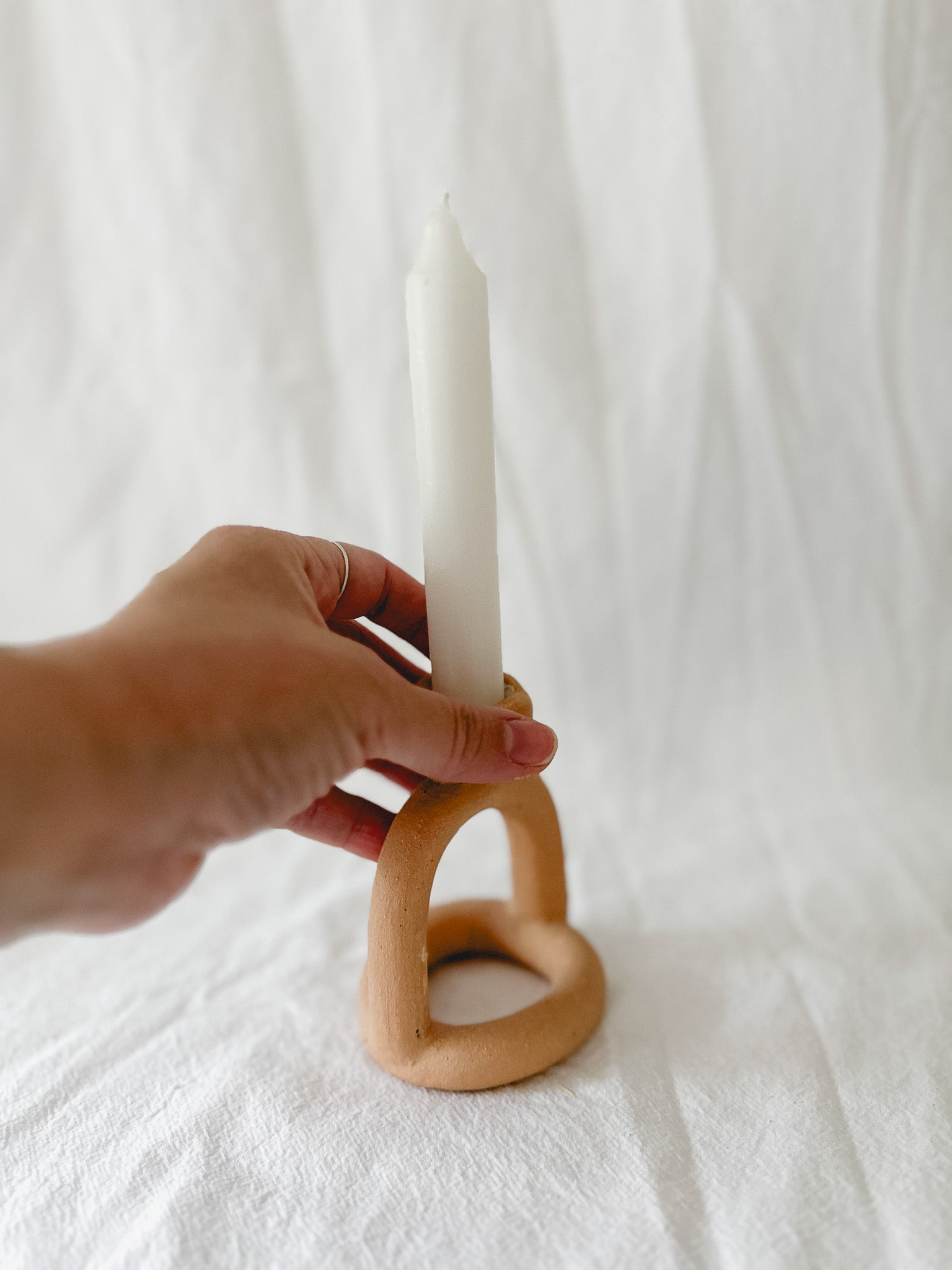 Handmade ceramic arc-shaped taper candle holder, seconds-sale piece from Muddy Heart