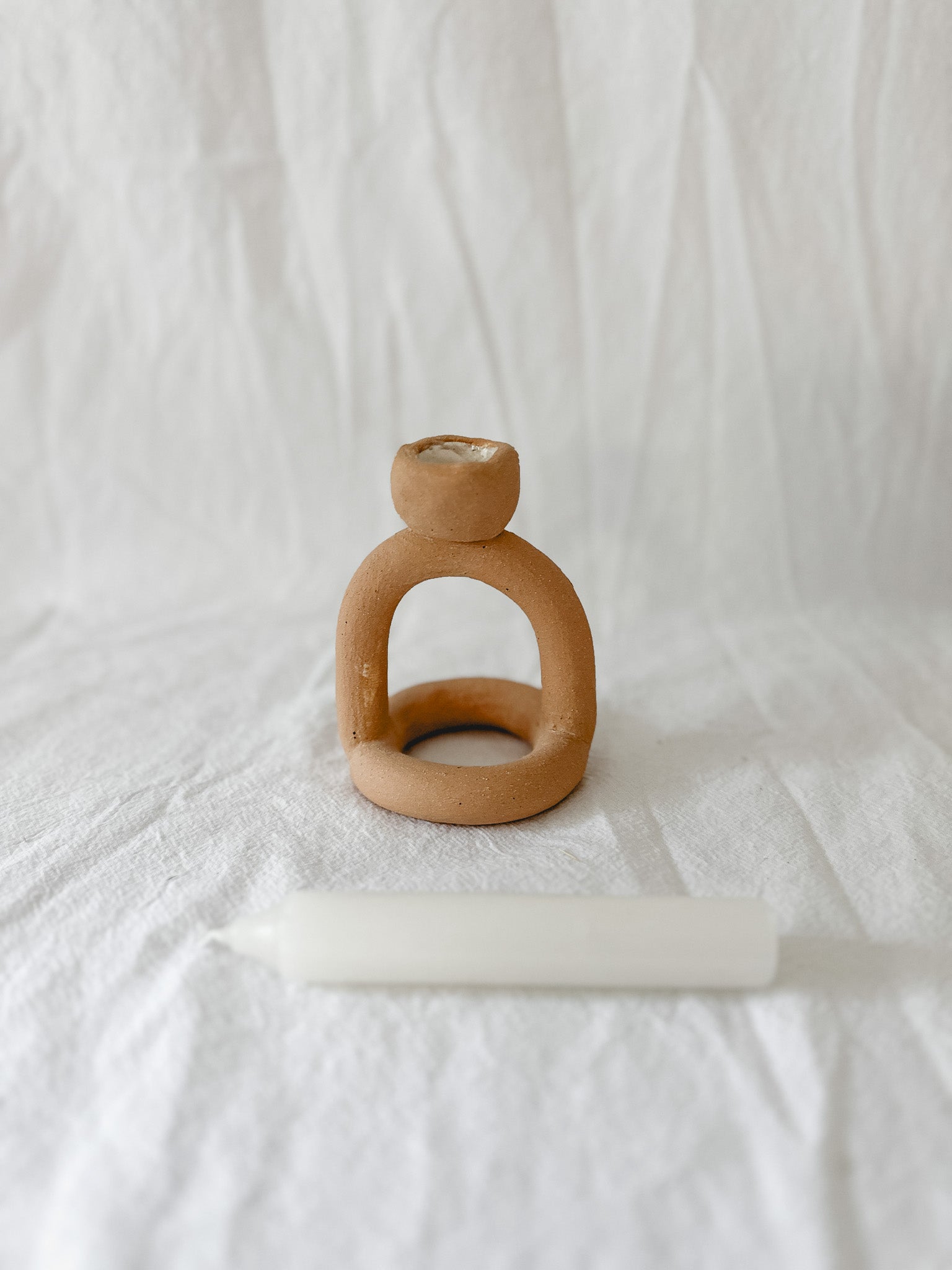 Handmade ceramic arc-shaped taper candle holder, seconds-sale piece from Muddy Heart