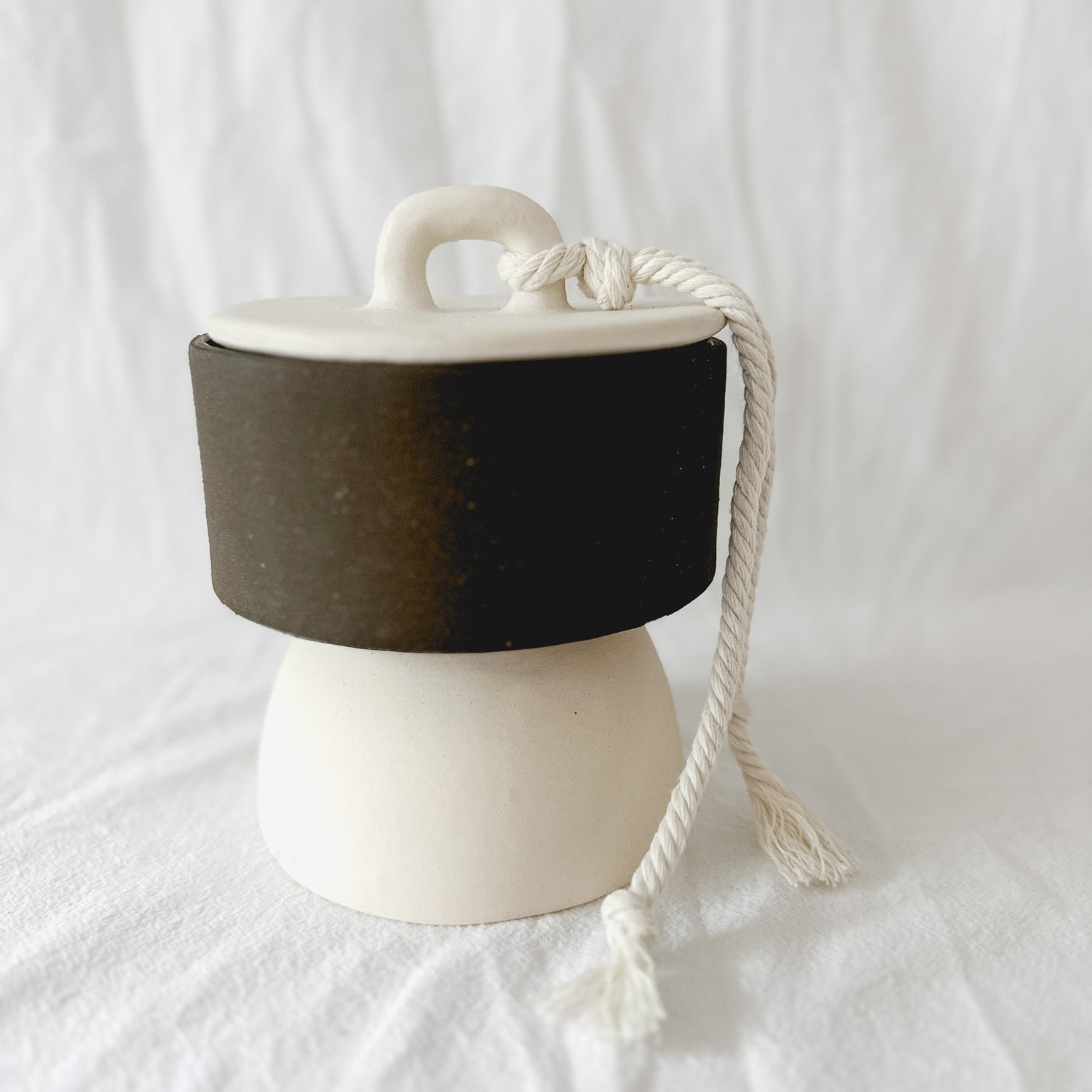 Handmade ceramic lidded vessel on a pedestal base for small storage, seconds-sale piece from Muddy Heart