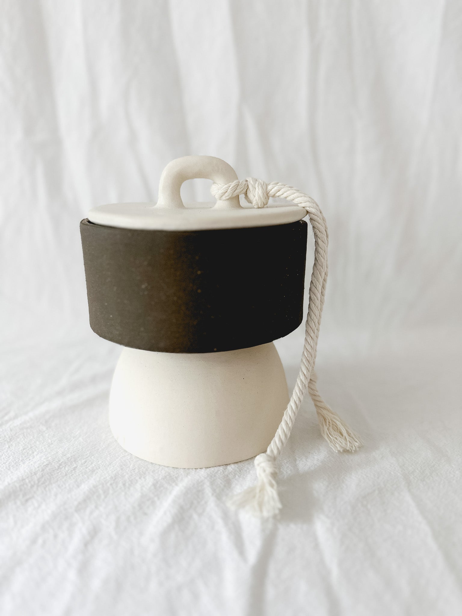 Handmade ceramic lidded vessel on a pedestal base for small storage, seconds-sale piece from Muddy Heart