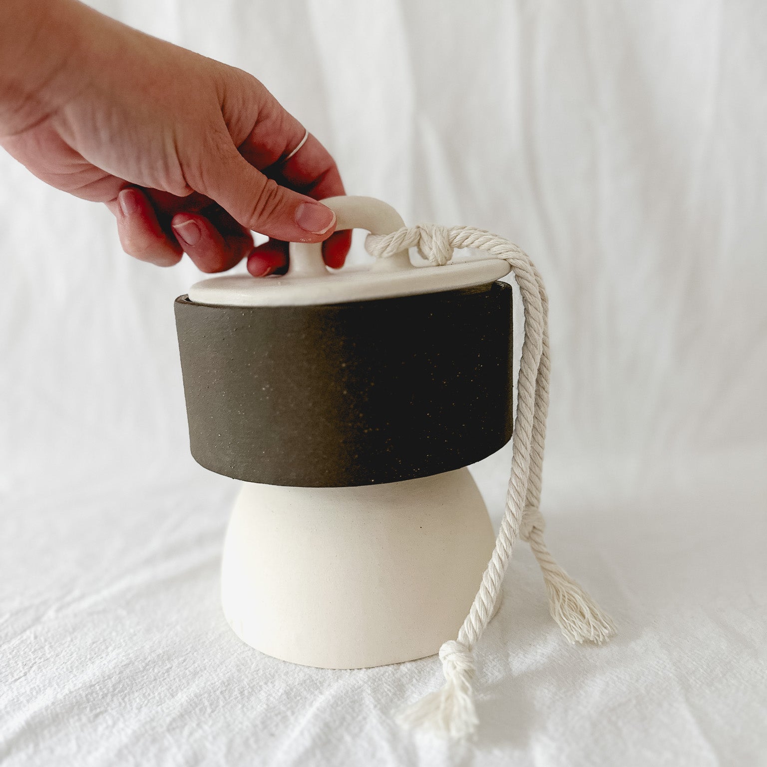 Handmade ceramic lidded vessel on a pedestal base for small storage, seconds-sale piece from Muddy Heart