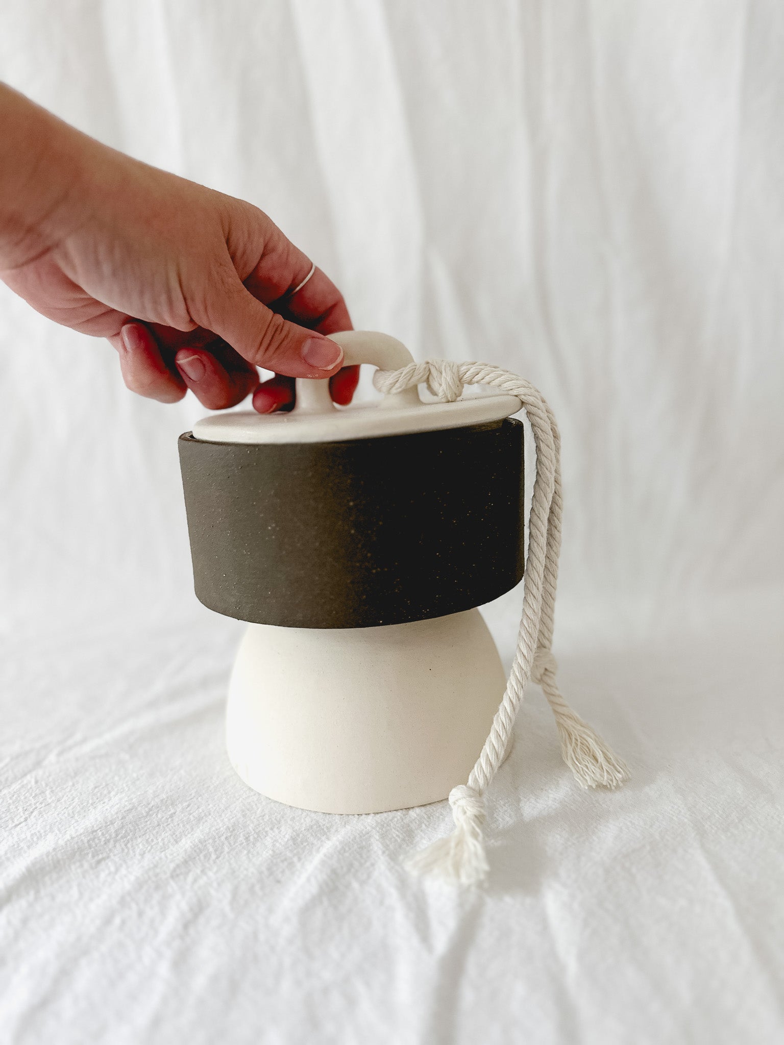 Handmade ceramic lidded vessel on a pedestal base for small storage, seconds-sale piece from Muddy Heart