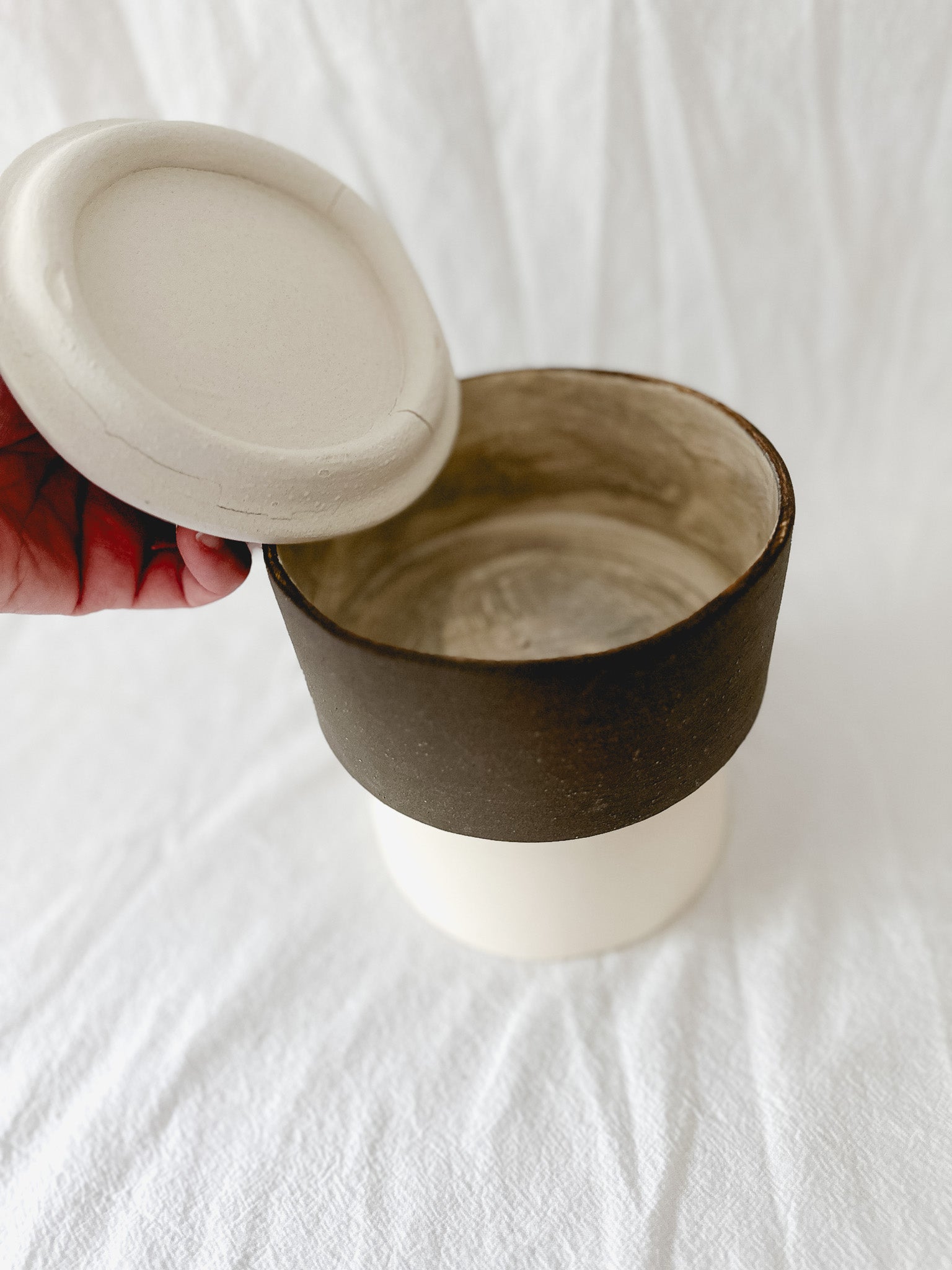 Handmade ceramic lidded vessel on a pedestal base for small storage, seconds-sale piece from Muddy Heart