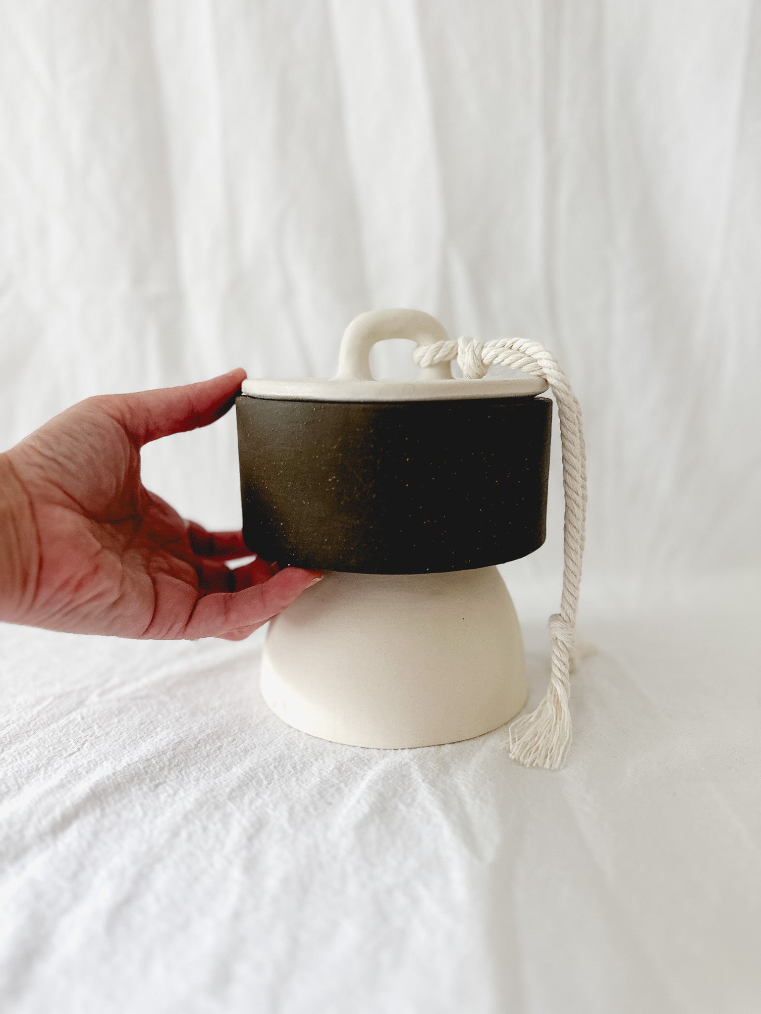 Handmade ceramic lidded vessel on a pedestal base for small storage, seconds-sale piece from Muddy Heart
