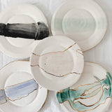 Handmade ceramic salad and dessert dishes with a watercolor glaze and real 22k gold luster line, seconds-sale pieces from Muddy Heart