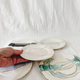 Handmade ceramic salad and dessert dishes with a watercolor glaze and real 22k gold luster line, seconds-sale pieces from Muddy Heart